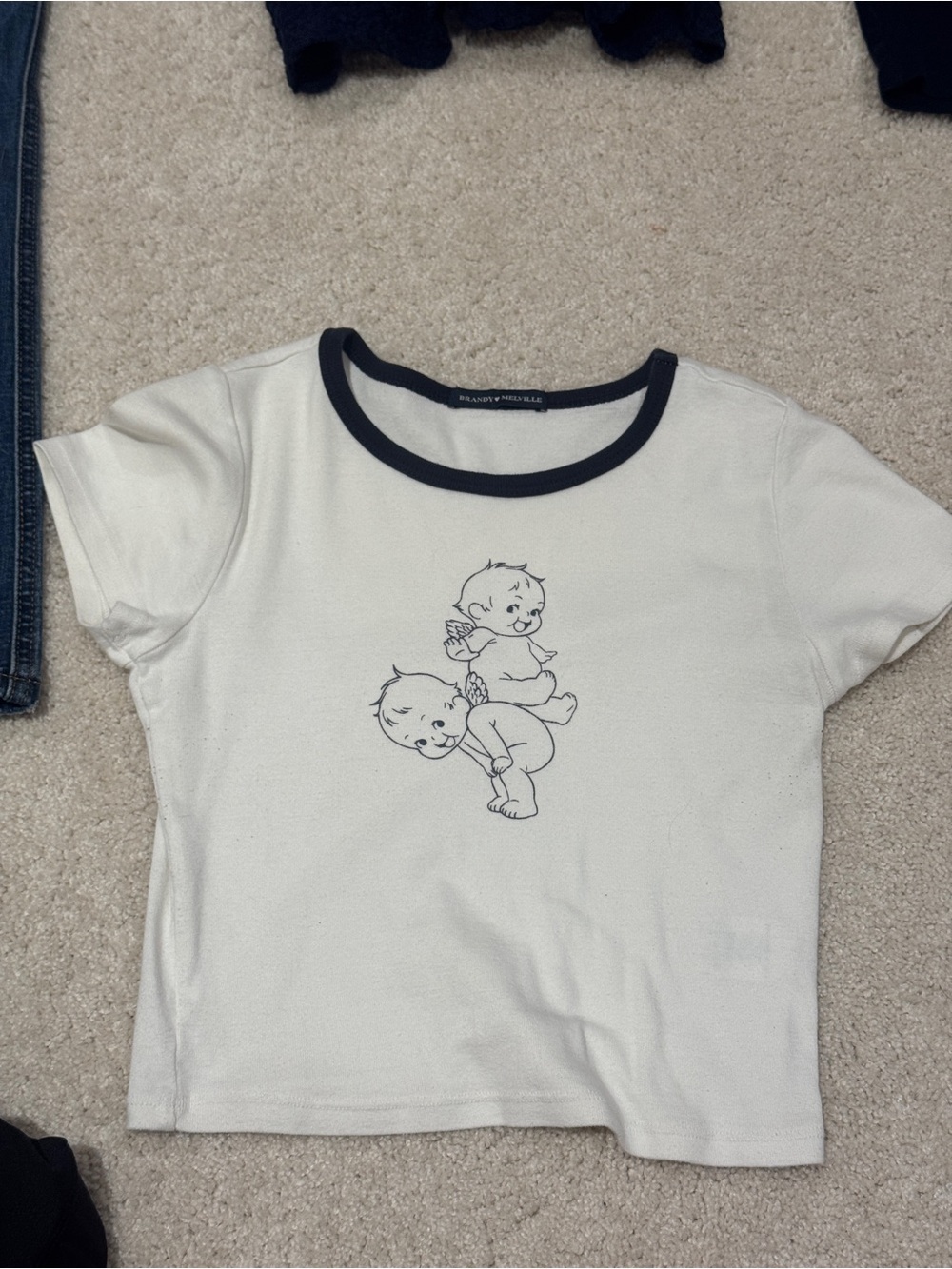 Brandy Melville White Tee with Navy Trim and Playful Baby Graphic